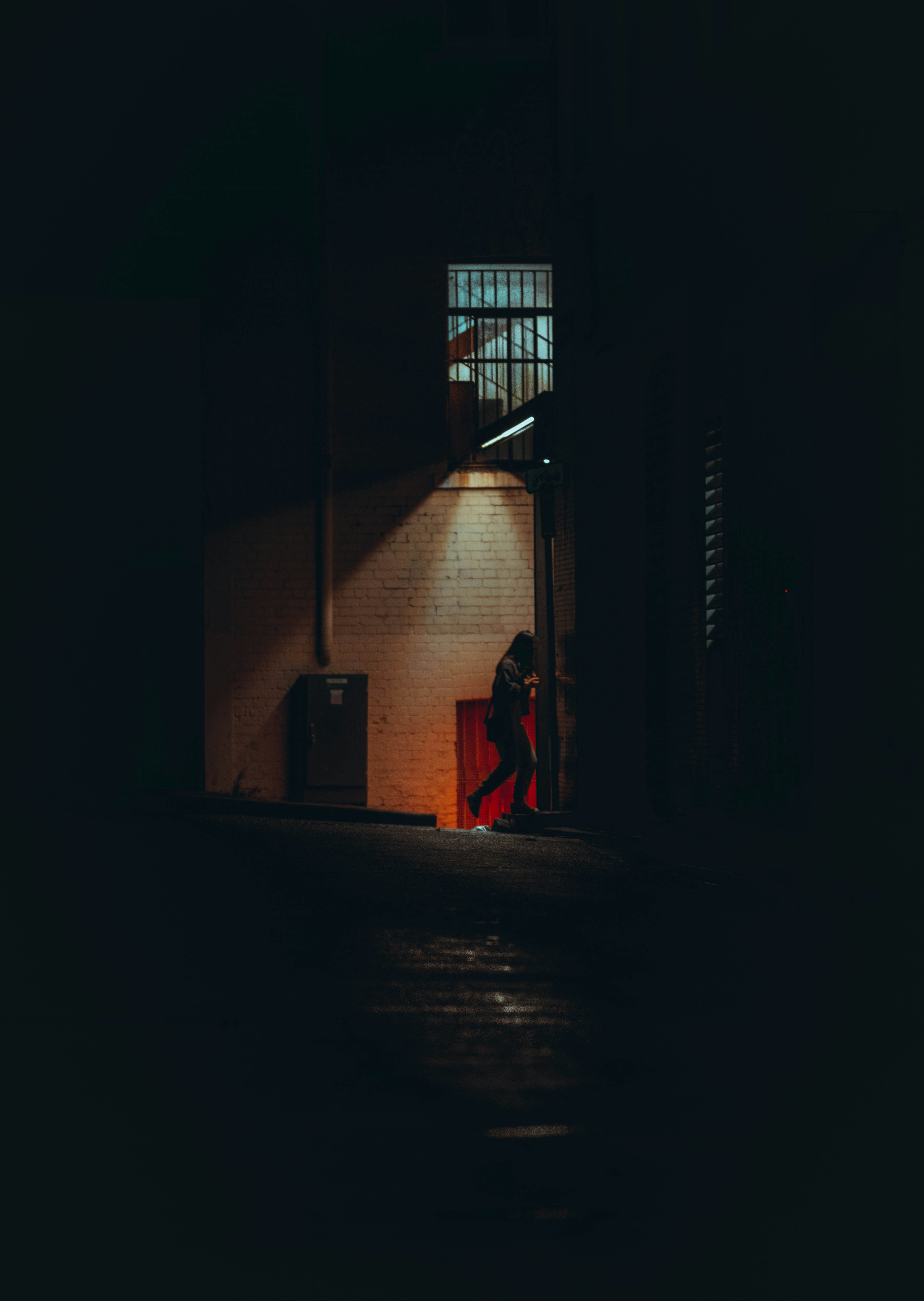 Silhouetted person in a dark room